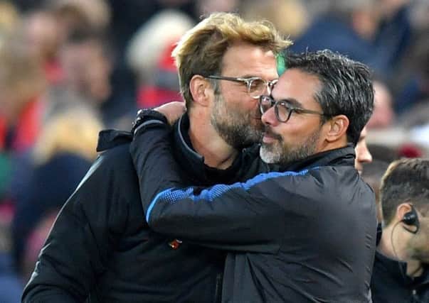 Liverpool manager Jurgen Klopp, left, and Huddersfield Town counterpart David Wagner embrace after the final whistle at Anfield (Picture: Dave Howarth/PA Wire).