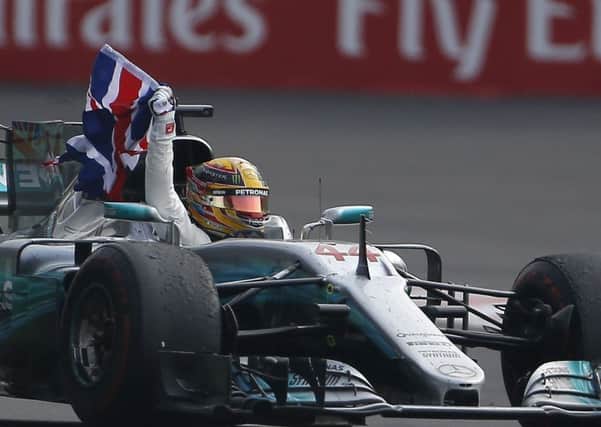 British driver Lewis Hamilton celebrates wining his fourth Formula One championship.
