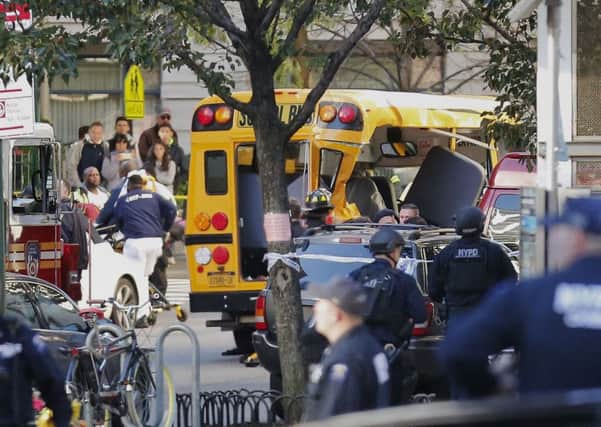 Authorities respond near a damaged school bus. (AP Photo/Bebeto Matthews)