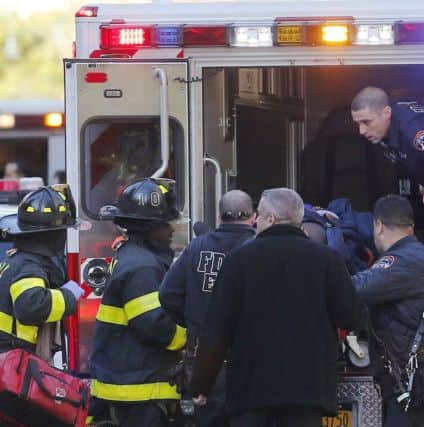 Paramedics lift an individual into an ambulance near the scene after reports of a deadly shooting. (AP Photo/Bebeto Matthews)