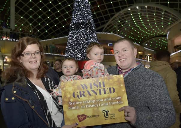 Wishmas Tree Fund raisers Sam and Michael Jameson-briggs with three year old twins Ella and Sophie of Wakefield who made the first wish and were given a holiday in Florida from Trinity.