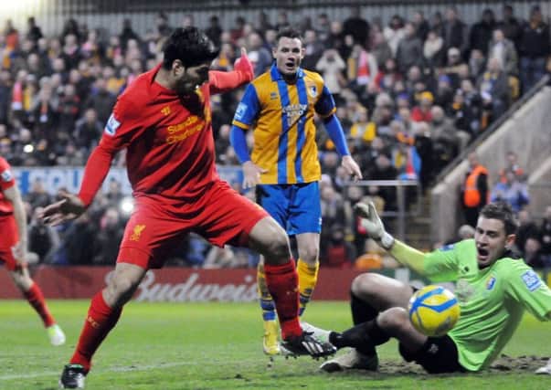 Luis 
Suarez scores a controversial goal for Liverpool against Mansfield Town in the FA Cup five seasons ago.
