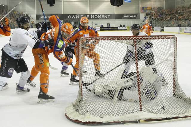 Andrew Deveaux, left, scores his first Sheffield Steelers goal in last week's 6-0 win over Braehead Clan. Picture: Hayley Roberts.