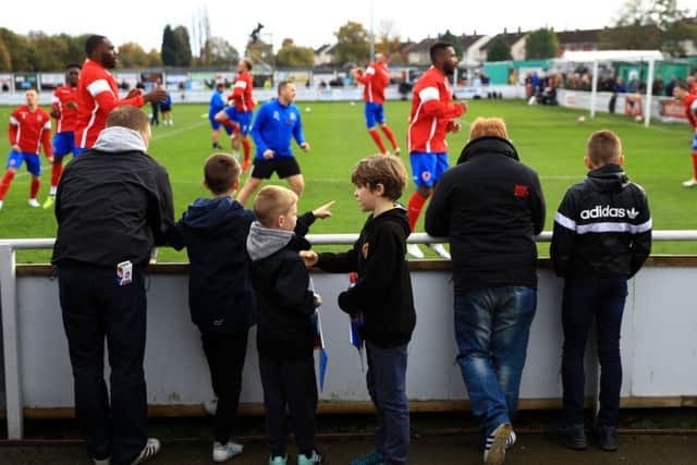 Shaw Lane Association fans watch their team warm-up at Sheerian Park. Picture: Tim Goode/PA.