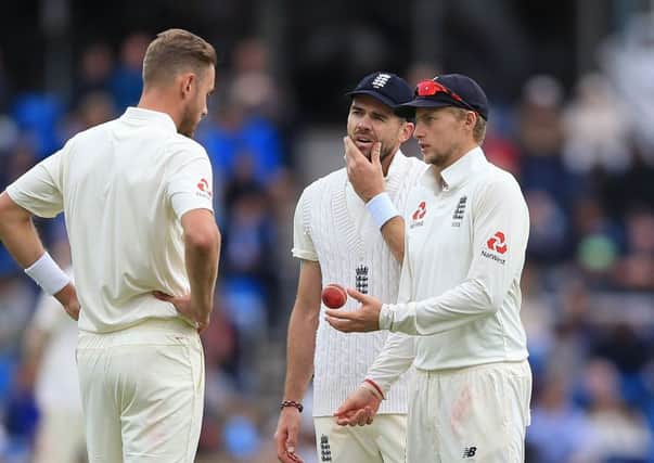 HELPING HAND: England's captain Joe Root (right) talks to Stuart Broad (left) and James Anderson, centre. Picture: Nigel French/PA