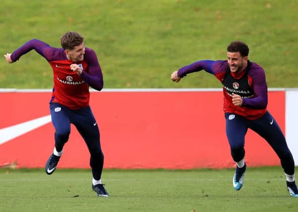 Englands John Stones, left, and Kyle Walker laugh and joke during a sprint in Englands training session in Burton (Picture: Mike Egerton/PA Wire).