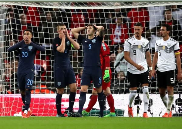 Jesse Lingards disappointment at missing a late chance to win the game for England against Germany is shared by Eric Dier, centre, and John Stones, right (Picture: Nick Potts/PA).