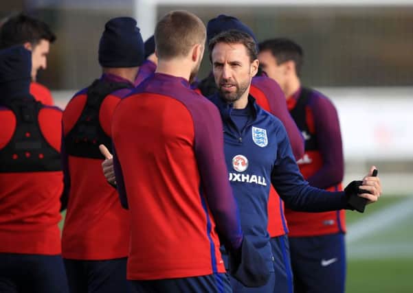 England manager Gareth Southgate talks to Eric Dier who will captain the Three Lions against Brazil at Wembley tonight (Picture: Mike Egerton/PA Wire).