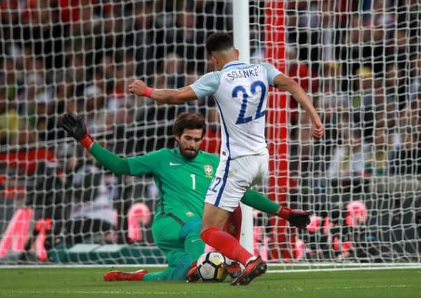 Englands Dominic Solanke has a shot blocked by Brazil goalkeeper Alisson Becker as the hosts threatened to grab a late winner at Wembley (Picture: Mike Egerton/PA Wire).