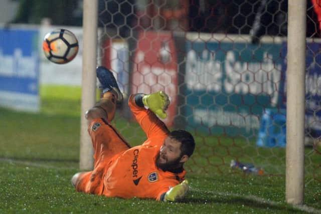 Guiseley's Jonny Maxted saves his first penalty from 
Accrington Stanley in tghe shoot-out (Picture: Bruce Rollinson).