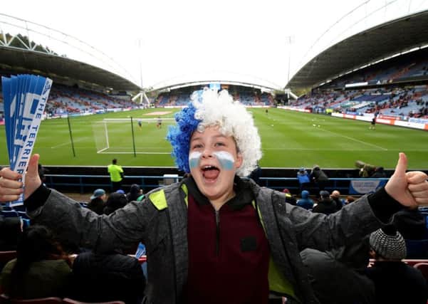 A young Huddersfield Town fan in the stands before the Premier League match at the John Smith's Stadium, Huddersfield.