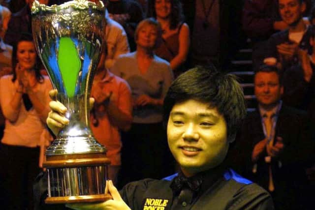 TOP MAN: Ding Junhui celebrates beating England's Steve Davis in the UK Championship Final at York's Barbican Centre in 2005. Picture: Alistair Wilson/PA.