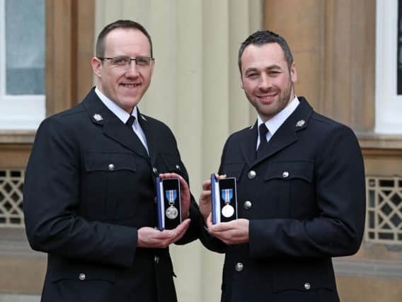 West Yorkshire Police Constables Craig Nicholls (left) and Jonathan Wright after they were awarded The Queen's Gallantry Medal by the Prince of Wales during an Investiture ceremony at Buckingham Palace, London, for arresting MP Jo Cox's murderer.