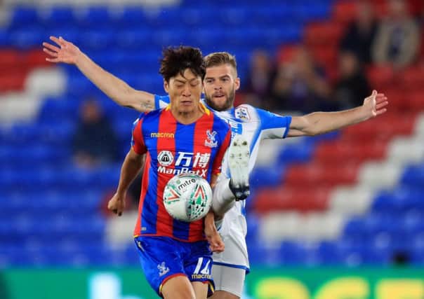 Crystal Palace's Lee Chung-yong (left) and Huddersfield Town's Martin Cranie battle for the ball during the Carabao Cup earlier this season. Picture: Adam Davy/PA