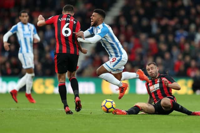 Huddersfield Town's Elias Kachunga is tackled by AFC Bournemouth's Steve Cook at Dean Court (Picture: Andrew Matthews/PA Wire).