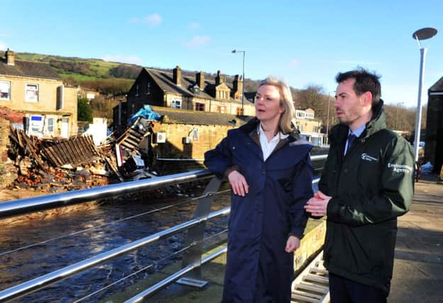 A library image from January 2016 of Elizabeth Truss MP, Secretary of State for Environment, Food and Rural Affairs  with Adrian Gill, Area Flood Risk manager for the Environment Agency during a  visit to Mytholmroyd following the floods of December 2015. Picture Tony Johnson