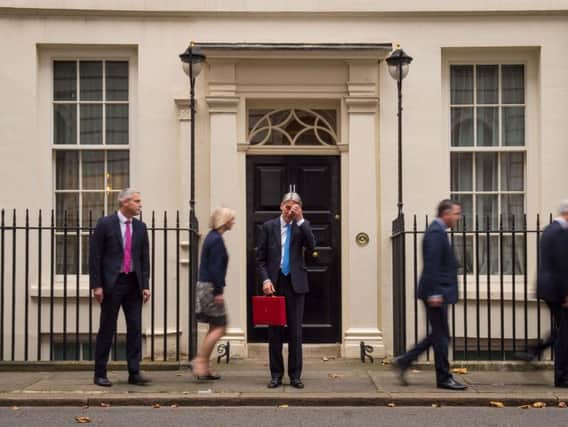 Chancellor Philip Hammond stands outside Number 11 Downing Street