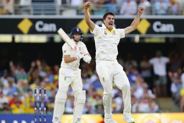 Australia's Pat Cummins celebrates taking the wicket of England's Joe Root. Picture: Jason O'Brien/PA