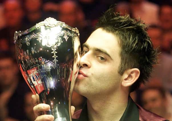 Ronnie O'Sullivan kisses the trophy after a 10-1 win over Ken Doherty, in the UK Championship snooker final at the Barbican Centre in York.