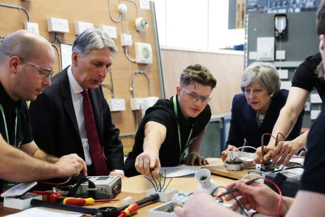 Prime Minister Theresa May and Chancellor of the Exchequer Philip Hammond during a visit to Leeds College of Building, a specialist further and higher education construction college. PRESS ASSOCIATION Photo. Picture date: Thursday November 23, 2017. Photo credit should read: Owen Humphreys/PA Wire