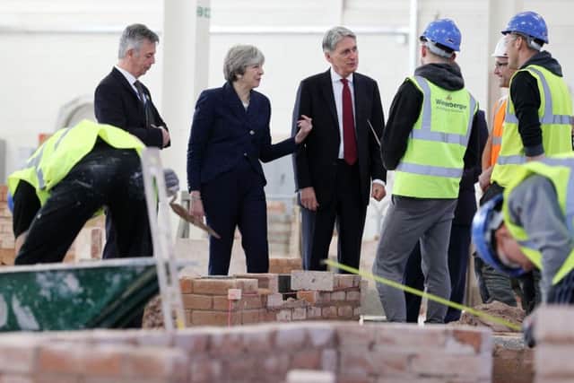 Prime Minister Theresa May and Chancellor of the Exchequer Philip Hammond during a visit to Leeds College of Building, a specialist further and higher education construction college. PRESS ASSOCIATION Photo. Picture date: Thursday November 23, 2017. Photo credit should read: Owen Humphreys/PA Wire