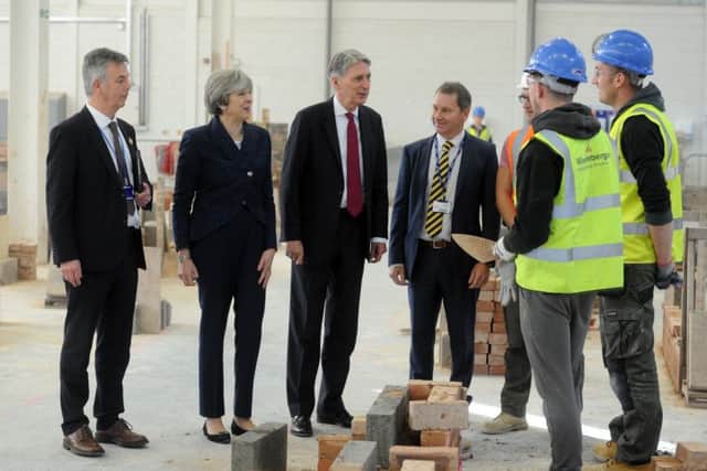 23  November 2017 .......      Prime Minister Theresa May and Chancellor Philip Hammond during a visit to Leeds College of Building, a specialist further and higher education construction college.  Picture Tony Johnson