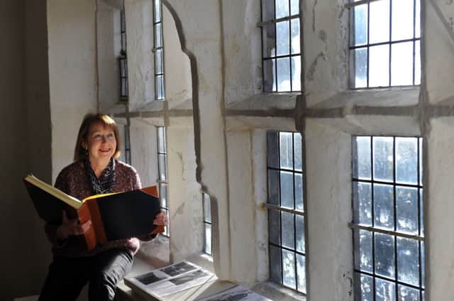 Hazel Richardson, Heritage Project Officer, looking through the Tom Twisleton Celebration  exhibition  at The Folly in Settle