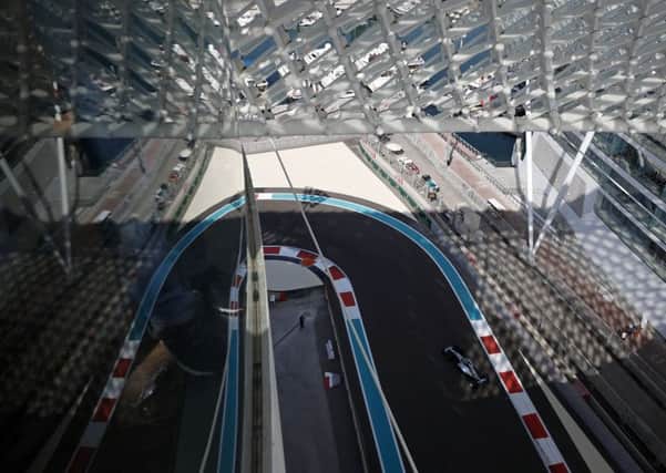 Mercedes driver Lewis Hamilton approaches a curve during the first free practice at the Yas Marina racetrack in Abu Dhabi. Picture: AP Photo/Hassan Ammar