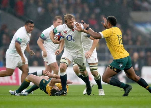 England's Chris Robshaw (centre) is tackled by Australia's Bernard Foley (second left) and Samu Kerevi (right) at Twickenham last week. Picture: Nigel French/PA