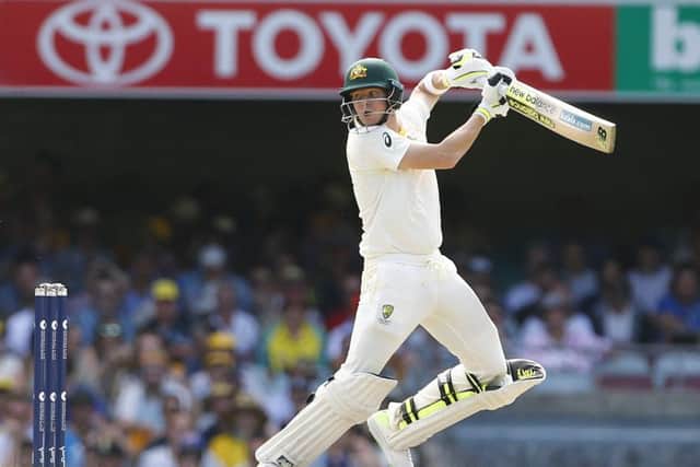 Australia's Steve Smith late cuts for four against England at The Gabba. Picture: Jason O'Brien/PA