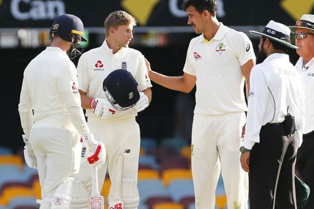 England's Joe Root is struck by a delivery from former Yorkshire team-mate Mitchell Starc during day three of the Ashes Test match at The Gabbao. Picture: Jason O'Brien/PA