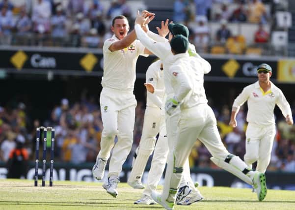 Australia's Josh Hazelwood celebrates the wicket of England's James Vince at The Gabba: Jason O'Brien/PA.