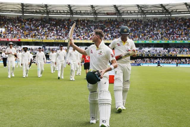 Australia's Steve Smith acknowledges the crowd as he walks off at tea unbeaten during day three at The Gabba. Picture: Jason O'Brien/PA