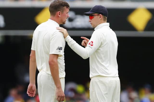 CALMING INFLUENCE: England captain Joe Root talks with Jake Ball during day three at The Gabba. Picture: Jason O'Brien/PA