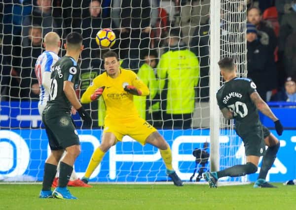 Manchester City's Nicolas Otamendi scores an own goal to put Huddersfield Town ahead just before half-time. But City hit back to win 2-1 (Picture: Danny Lawson/PA Wire).
