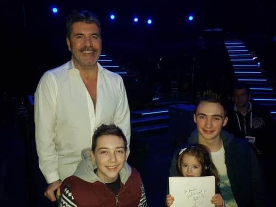 Timothy and his family meet up with Simon Cowell.