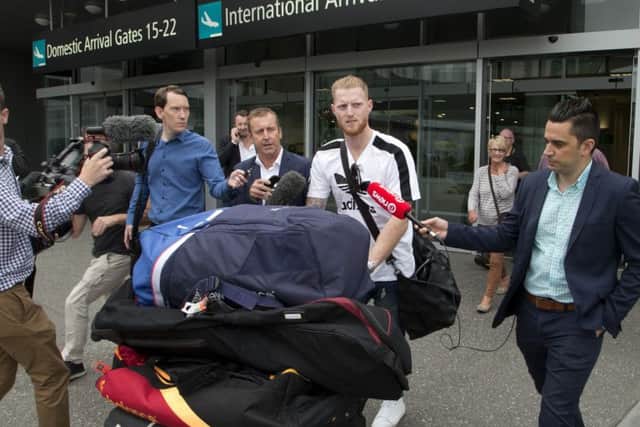 New Zealand-born England cricket star Ben Stokes is surrounded by media as he arrives in Christchurch, New Zealand. Picture: AP/Mark Baker