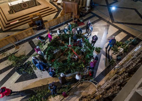 LARGE TASK: York Minsters advent wreath is assembled and then raised beneath the Central Tower. PIC: James Hardisty