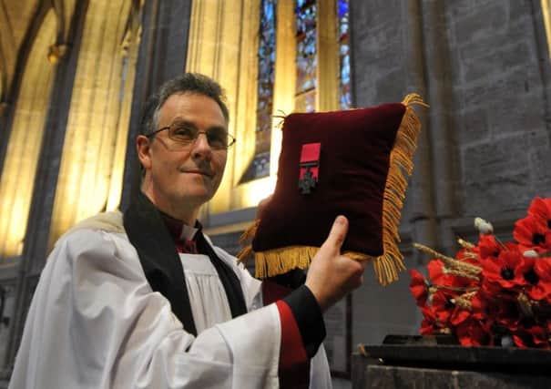 The Dean of Ripon Cathedral the Very Rev John Dobson, with the Victoria Cross awarded to  Lt Col Neville Bowes Elliott-Cooper.