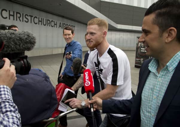 LONG ROAD BACK: Ben Stokes is surrounded by media as he arrives in Christchurch. Picture: AP/Mark Baker
