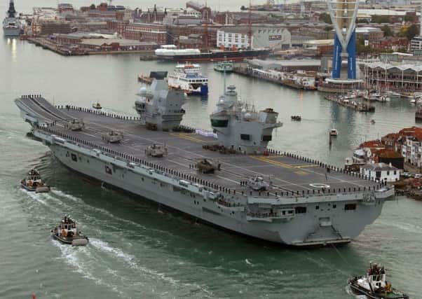 ALL ABOARD: HMS Queen Elizabeth, the UKs newest aircraft carrier, sailing past the Spinnaker Tower, Portsmouth.