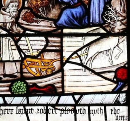 One of the stained glass windows in Derbyshire telling the story of St Robert and the Deer