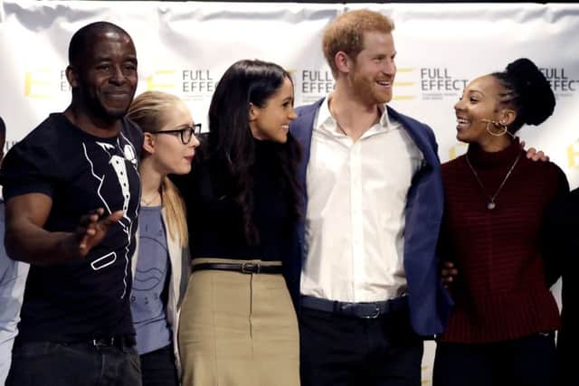 Prince Harry and Meghan Markle (centre) pose for a photograph with the cast of a hip hop opera performed by young people involved in the Full Effect programme during a visit to the Nottingham Academy