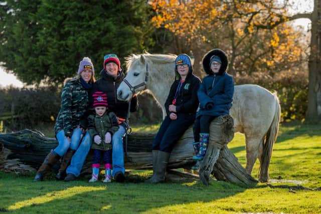 One of the families who attends the centre, (left to right) Emma Webster, 30, with husband Lee, 32, holding one of the centre's ponies called Blackjack, also their children Alexis, 5, Kallum, 13, and Kacey-Louise Webster, 10, of Ripon.