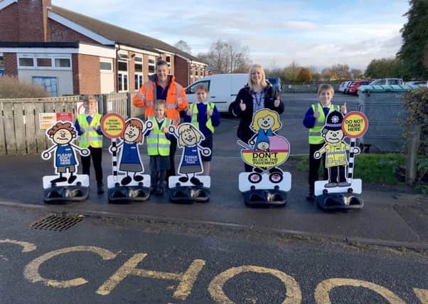 CAMPAIGN: Children from Ainderby Steeple Primary School with the new signs.