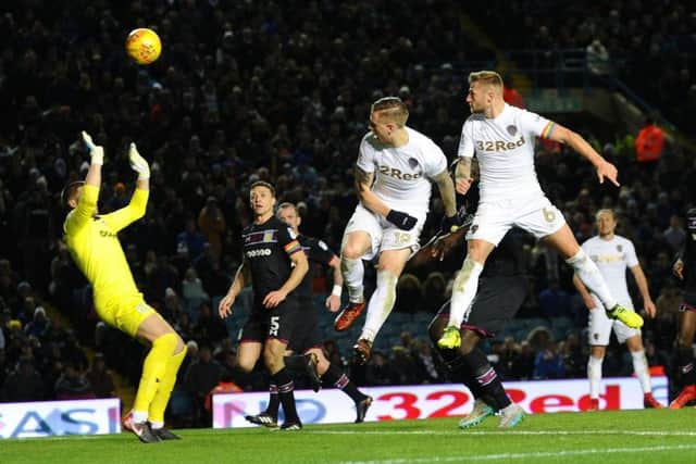 Liam Cooper, right, beats Leeds United team-mate Pontus Jansson to the ball  to head home past Aston Villa goalkeeper Sam Johnstone but the effort was ruled out (Picture: Jonathan Gawthorpe).