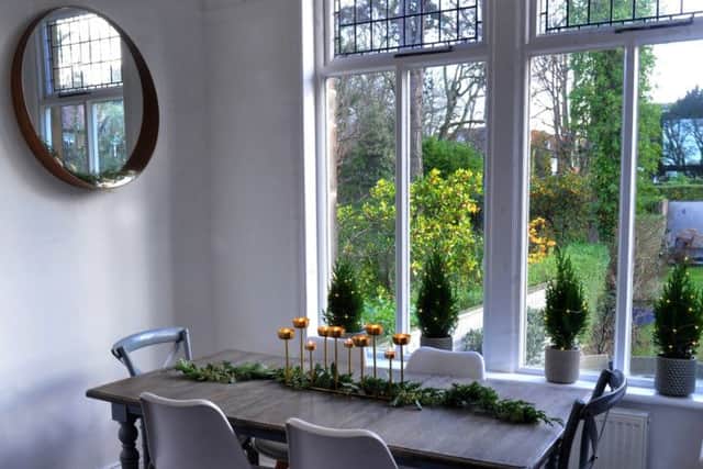 The dining table from Oka has had its legs painted grey by Lucy who used a runner of fresh greenery on top with a candelabra from Marks and Spencer as a centrepiece. The mini trees are sold at Lucy's shop in Harrogate