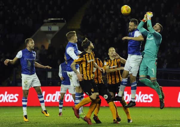 Hull City goalkeeper Allan McGregor puches the ball clear of Sheffield Wednesday's Atdhe Nuhiu (Picture: Steve Ellis).