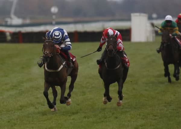 Total Recall ridden by Paul Townend (right) trail Whisper ridden by Davy Russel up the home straight before going on to win The Ladbrokes Trophy Race at Newbury.