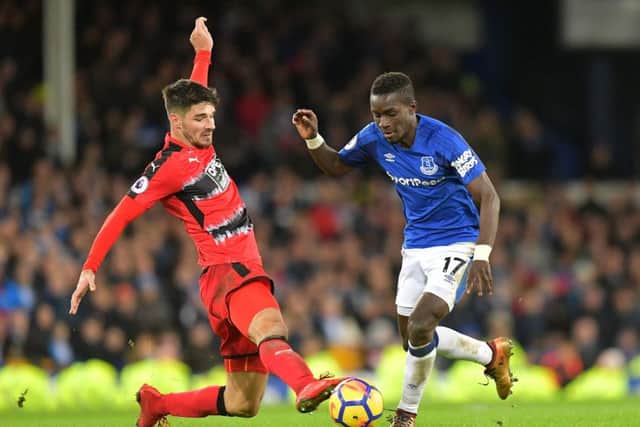 Huddersfield Town's Christopher Schindler (left) and Everton's Idrissa Gueye battle for the ball at Goodison Park on Saturday. Picture: : Dave Howarth/PA